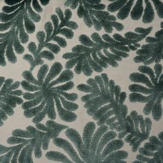 a green and white fabric with leaves on it