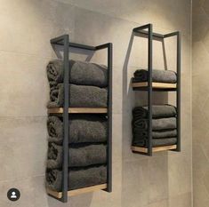 two shelves with towels hanging on them in a bathroom