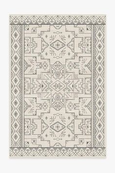 a beige and black rug with an intricate design on the bottom, in front of a white background