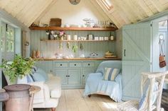 a living room filled with furniture and lots of storage under a pitched roof over looking the ocean