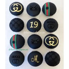 gucci cupcakes with black frosting and gold numbers are arranged in rows