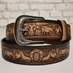 MEN'S LEATHER BELT.Give yourself a gift that you truly deserve! Wear the western leather Belt for Him and show off that sophisticated taste in clothes and accessory while giving off that classic, rodeo vibe. •MADE FROM EXCELLENT QUALITY LEATHER, it comes with pristine genuine leather that is hand-crafted and tested through time.•WITH AN EMBOSSED BULLS & HORSES DESIGN, it shows your true love for the western style giving you that laidback cowboy look.•INCLUDES AN EASY SNAP BACK STRAP DESIGN t Hand Tooled Leather Belt Buckles For Ranch, Leather Belt Buckles For Rodeo, Rustic Leather Belt Buckles For Rodeo, Western Leather Belt Buckles For Rodeo, Hand Tooled Leather Belts For Western-themed Events, Rustic Leather Belt Buckles For Ranch, Western Leather Belt For Western-themed Events, Adjustable Leather Belts For Rodeo, Adjustable Leather Belt For Rodeo