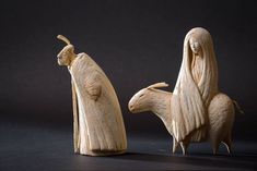 two carved wooden figurines depicting the birth of jesus