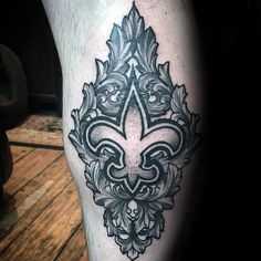 a black and white tattoo design on the leg