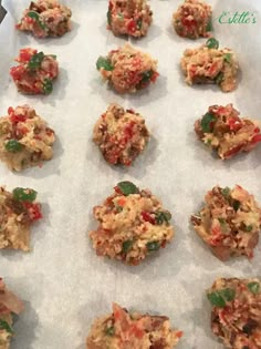 an assortment of cookies sitting on top of a baking sheet