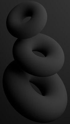 three black donuts stacked on top of each other in the shape of a number