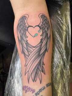 a tattoo with an angel heart and wings on it