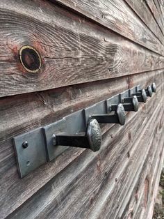 an old wooden wall with metal handles and knobs