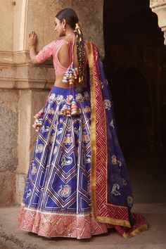 Indigo blue lehenga with peacock and elephant embroidered motifs. Paired with embroidered blouse and embroidered dupatta.
Component: 3
Pattern: Embroidered
Type Of Work: Gota, Sequins, Resham and Mirror
Neckline: V Neck
Sleeve Type: Short Sleeves
Fabric: Silk
Color: Blue
Other Details: 
Fringe bordered dupatta
Embroidered blouse
Back tassel tie-up
Occasion: Sangeet, Destination Wedding - Aza Fashions Festive Blue Kundan Sets, Fitted Meenakari Lehenga For Traditional Ceremonies, Chanderi Choli With Meenakari For Diwali, Diwali Chanderi Choli With Meenakari Details, Diwali Chanderi Choli With Meenakari, Blue Lehenga For Festive Occasions, Diwali Kundan Lehenga With Motifs, Diwali Meenakari Choli In Chanderi, Festive Blue Lehenga For Festivals