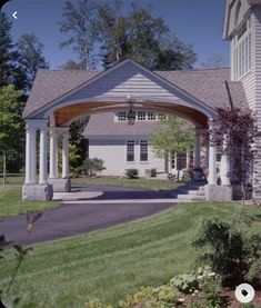 a large white house with a covered driveway