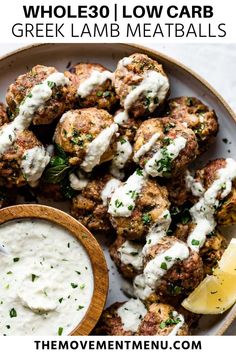 a white plate topped with meatballs covered in ranch dressing