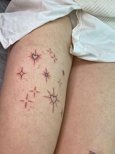 a woman's thigh with small stars on it