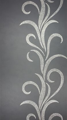 a black and white wall with an intricate design on it's side, painted in silver