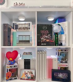 a book shelf filled with lots of books and other items on top of eachother