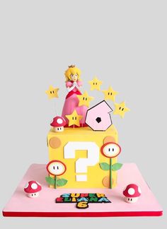 a cake that is decorated with mario and mushroom characters on it's top tier