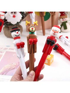 three christmas pencils in the shape of santa claus, snowman and reindeer figures