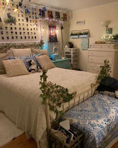 a bed room with a neatly made bed and lots of decorations on the wall above it