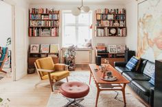 a living room filled with furniture and lots of books