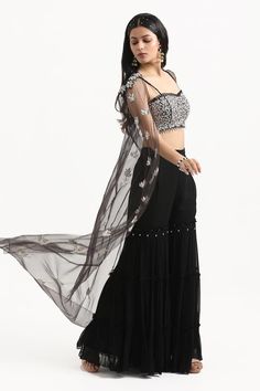 Black sheer cape with resham embroidered floral motifs highlighted by mirrorwork and beads. Comes with padded floral embroidered blouse and tiered sharara. - Aza Fashions Cape Sharara, Sheer Cape, Silk Cape, Sharara Set, Floral Motifs, Embroidered Silk, Embroidered Blouse, Set For Women, Black Silk