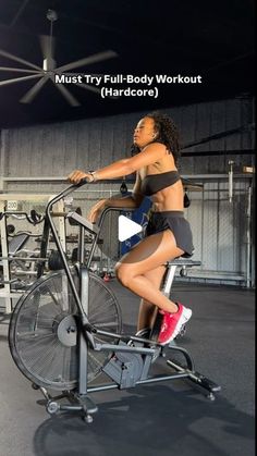 a woman riding an exercise bike in a gym