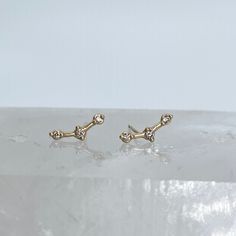 Three Round Cut Diamond 14k gold Stud Earrings made to resemble Orion's Belt. Can be made with yellow gold or rose gold.  * Metal: 14k Yellow Gold, 14k Rose Gold * Gemstone: Diamond * Stone Cut: Round * Number of stones: 3 * Setting Type: Bezel * Closure: Push Back Ready to ship in 6 weeks! All of our pieces are handmade and made to order. Message for questions about customization, including alternate gemstone or metal requests. 14k White Gold Ear Climbers, Single Rose Gold Ear Climber In 14k Gold, Rose Gold Single Ear Climber In 14k Gold, Rose Gold Celestial Earrings, Fine Jewelry 14k White Gold Ear Climbers, White Gold 14k Ear Climbers Fine Jewelry, White Gold 14k Fine Jewelry Ear Climbers, Gold Celestial Earrings For Formal Occasions, Yellow Gold-plated Ear Climbers As Gift