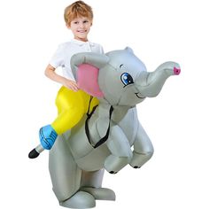 a young boy is riding on an inflatable toy elephant that looks like it has a yellow tube attached to its trunk