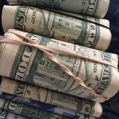 stacks of rolled up dollar bills tied together