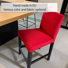 a red chair sitting in front of a wooden table