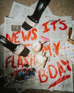 the newspaper is covered with news and other things to be seen on it, including high heeled shoes