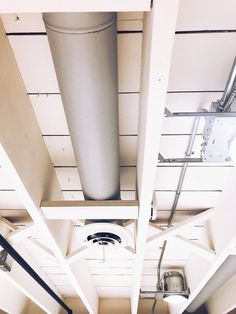 the inside of a building with pipes and lights