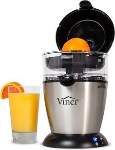 a juicer with an orange slice next to it and a glass of orange juice