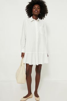 A sophisticated update to the closet staple shirt dress we love, the White Cotton Poplin Callahan perfectly merges classic and trendy. This mini seamlessly combines functional details like invisible side pockets and a button front half placket with a flirty flutter hemline to create a style that encapsulates unfussy femininity. We are pairing this tailored piece with flats or sneakers for a casual look and switching to heels when the occasion calls for it. Classic collar Long sleeves with button Classic A-line Cotton Shirt Dress, Feminine Cotton Shirt Dress For Day Out, Chic Mini Dress With Pleated Hem For Daywear, Chic Spring Shirt Dress With Pockets, Classic Midi Length Mini Dress For Daywear, Office Shirt Dress With Pockets, Chic Cotton Knee-length Shirt Dress, Classic Button-up Mini Dress For Spring, Classic Shirt Dress With Pockets And Spread Collar