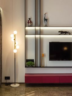 a living room with white walls and red carpeted flooring, lighted by modern lighting