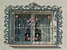 a window with iron bars and flowers on it