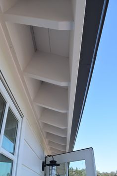 the roof of a house with white siding