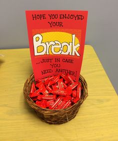 a basket filled with candy sitting on top of a table next to a sign that reads, hope you enjoyed your break just in case need another