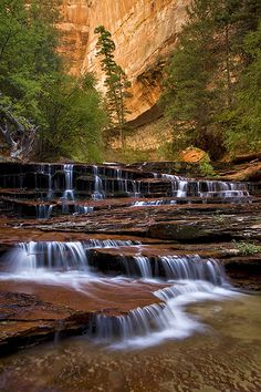 the water is running down the rocks in the canyon