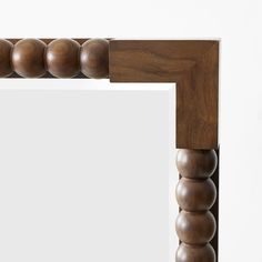 a close up of a wooden frame with balls on it