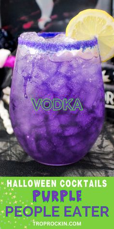 a purple drink in a glass with lemon wedges on top and the words vodka halloween cocktail