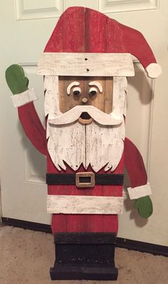 a wooden santa clause standing in front of a door