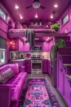 a purple couch sitting in the middle of a kitchen next to a stove top oven