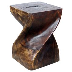 a wooden stool that is shaped to look like an abstract piece of wood with a curved edge