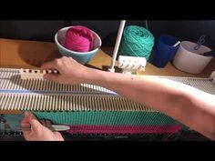 someone is working with yarn on a loom