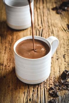 chocolate being poured into a white mug