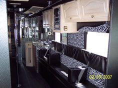 the interior of a bus with black and white decor on the walls, windows, and seats