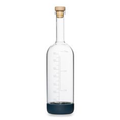 an empty glass bottle with a wooden stopper on the bottom and a measuring scale in it