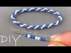 a bead bracelet being made with blue and white beads