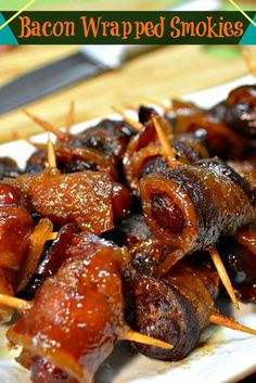 bacon wrapped smokies on a plate with toothpicks in the foreground