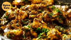 a close up of food in a pan with broccoli and spices on it