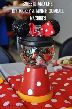 there is a bowl full of candy and minnie mouse ears on top of the bowl